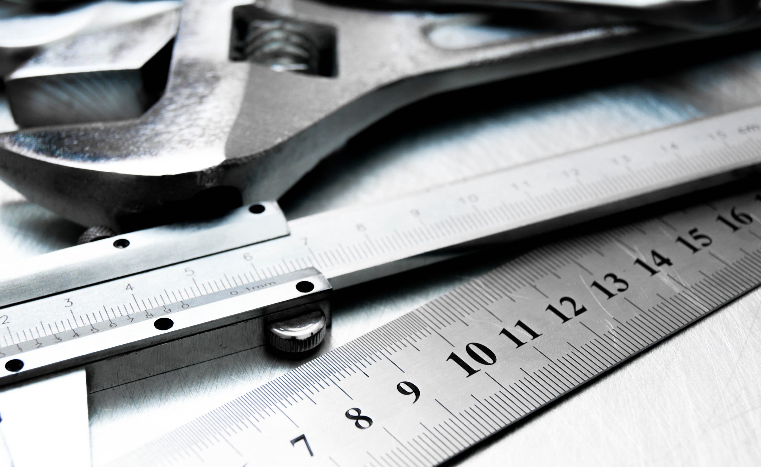 Many tools on the scratched metal background.