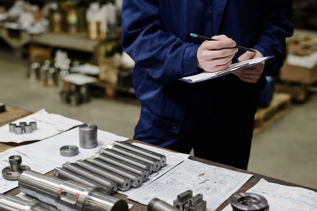 Unrecognizable Specialist Checking Metal Parts